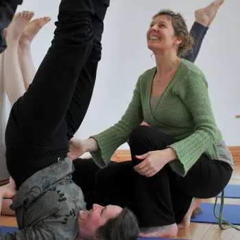 A female Yoga instructor teaches yoga, ladies practicing yoga to upward their legs