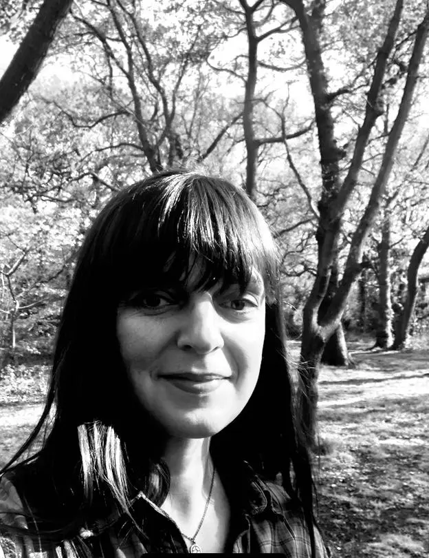 In a black, and white photo, she is capturing the beauty and power of nature in all its glory.