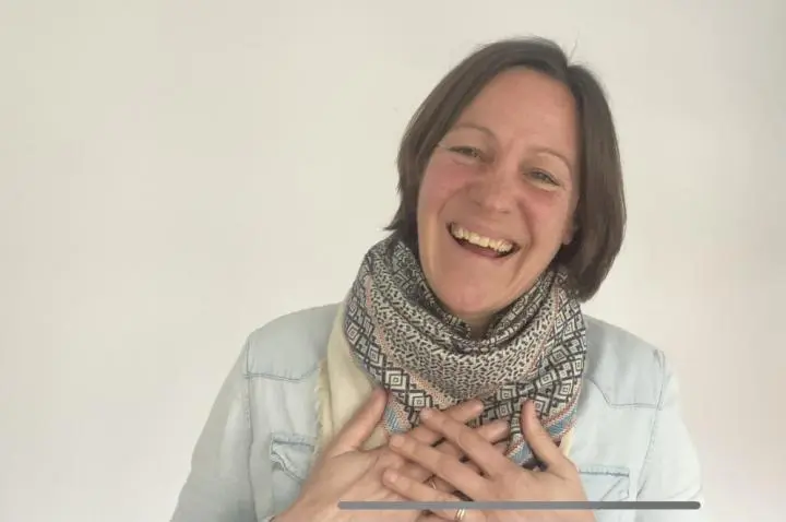 An old woman feeling happy in the massage room and both hands keeping to her chest