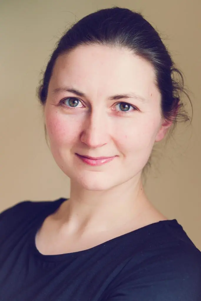 She is wearing a blue shirt & thinking about yoga