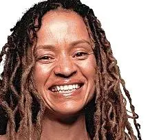 A 40+-year-old woman smiling in the yoga Nidra house, with a white background