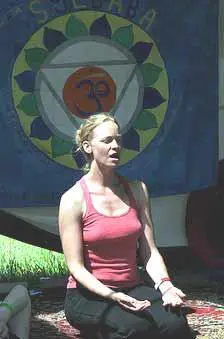 A Woman performing a yoga pose with their arms extended overhead