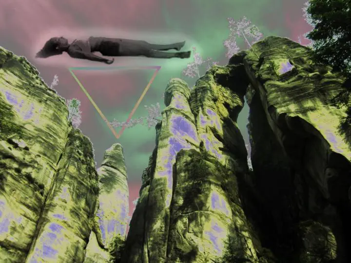 In photography: She is lying with the Corpse Pose, with a green and natural background.