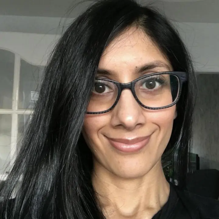 A woman is wearing glasses and looking at yoga class feeling better after doing a massage