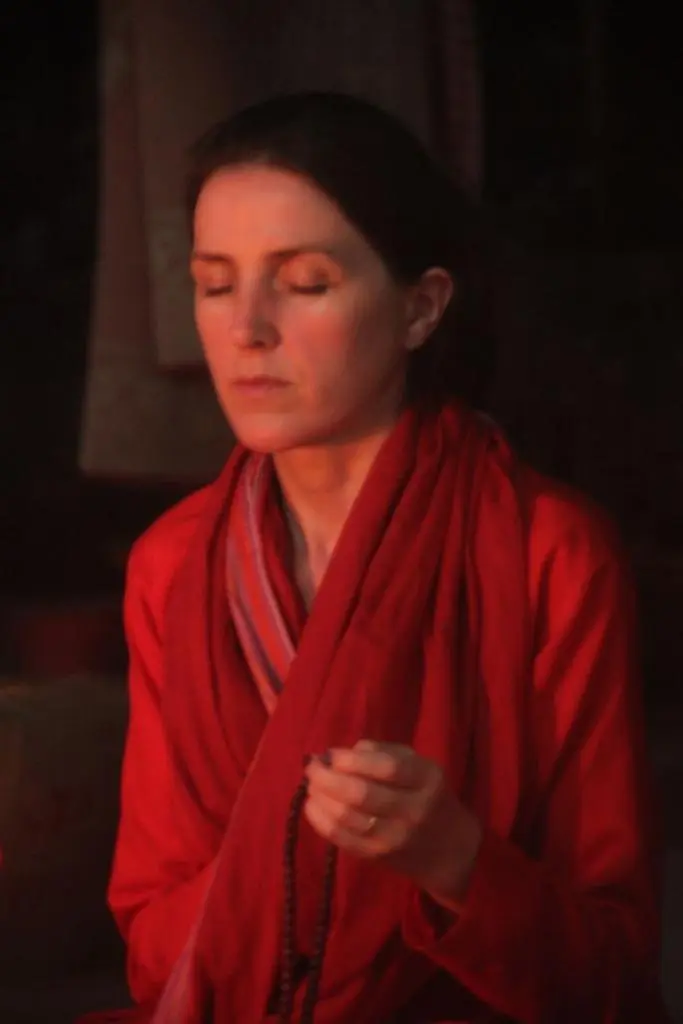 Young and beautiful female yoga instructor holding her hand Tasbih