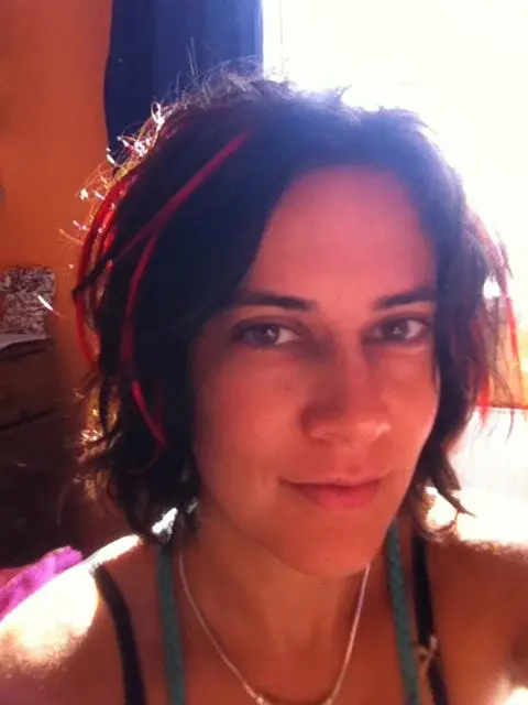 An adult lady sitting in the massage room feeling better after a massage