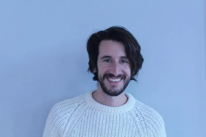 Mail Yoga Instructor wearing a white jersey