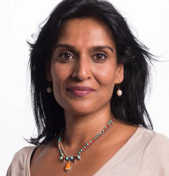 A woman with a wheatish appearance who wearing necklaces