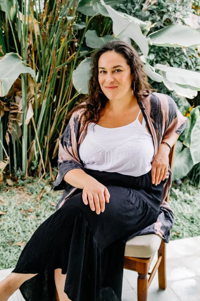 A lovely female Yoga sitting on a chair, with free printable chair yoga exercises