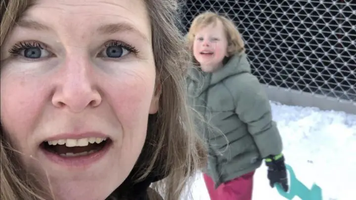 A mother capturing a selfie with her daughter in snow falling | yoga in my fresh air barn