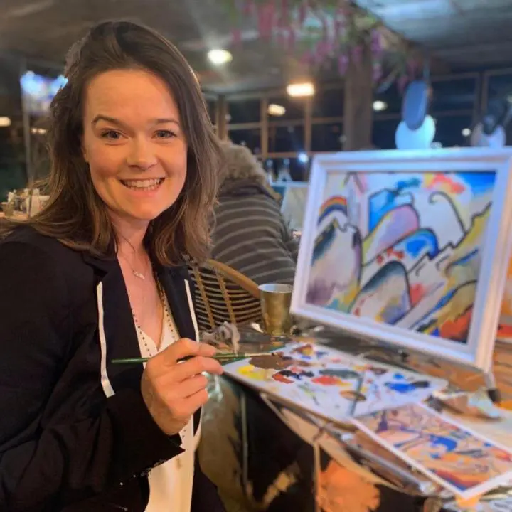 A girl taking a pen and is making a painting in the Yoga Nidra center