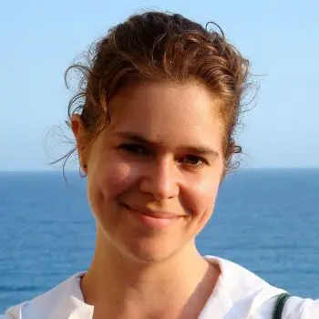 Girl smiling at the beach of the ocean | Hatha yoga