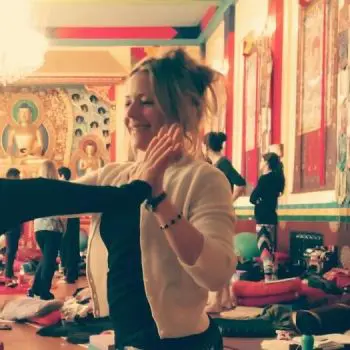 The yoga instructor Handshake with her student and her backside we can see many students