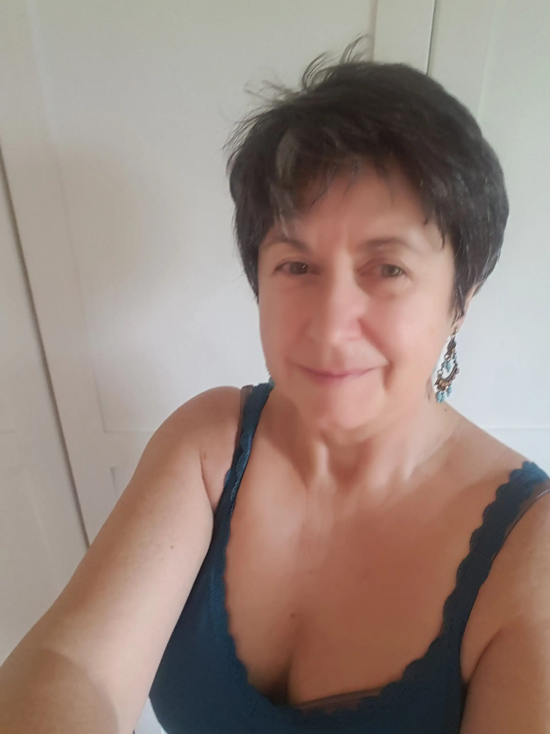 A woman who just wearing a bra standing in a massage room