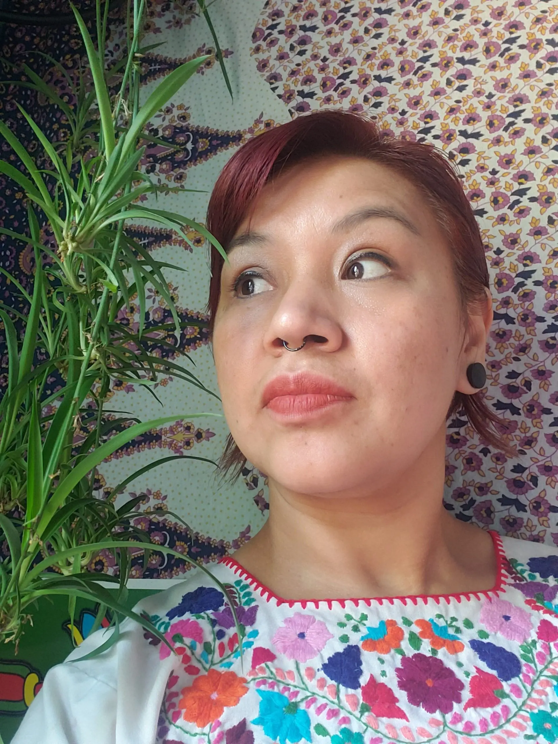 Female yoga instructor lying on Nidra's floor with the little plant