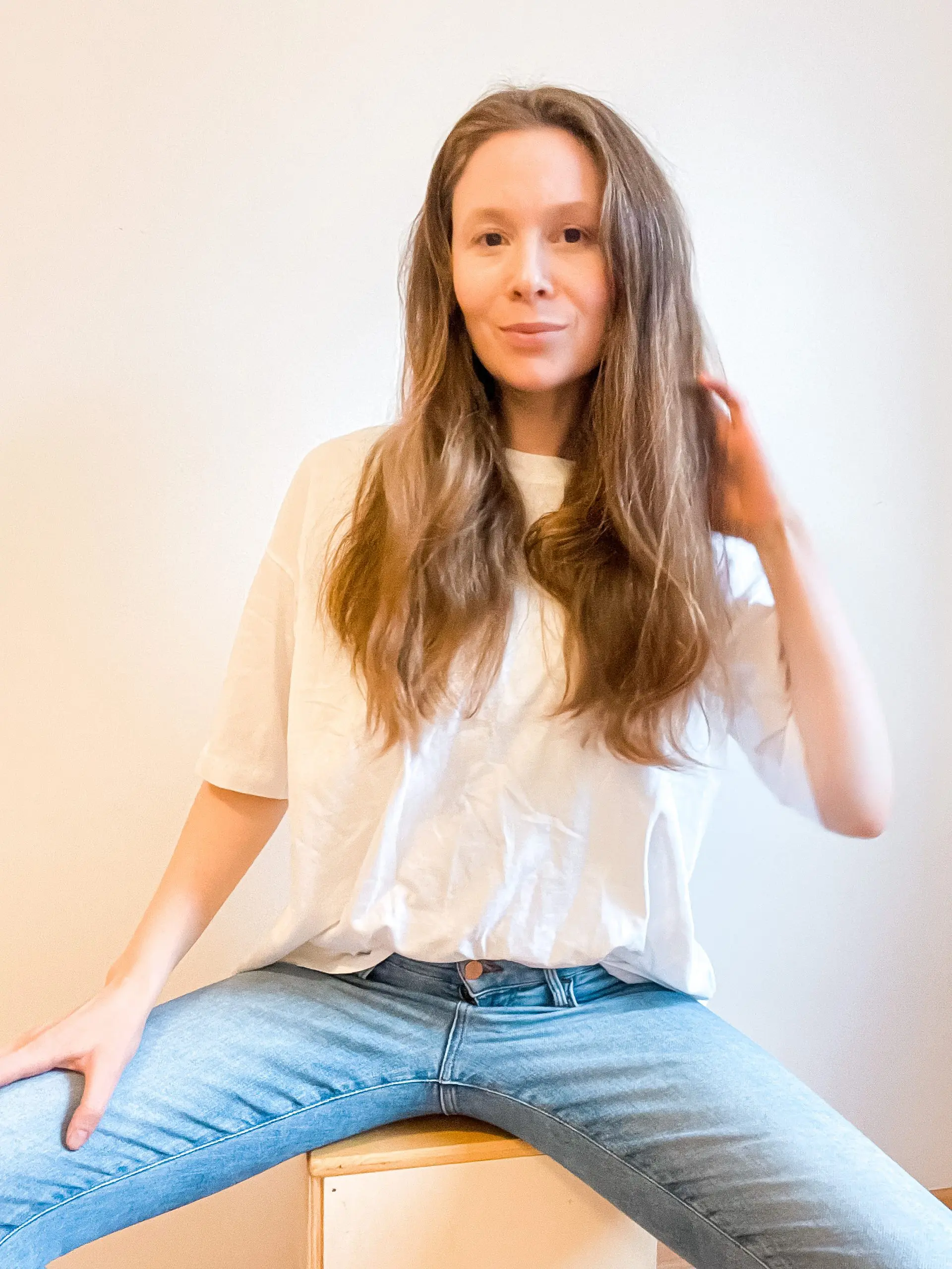 A beautiful long-haired young girl sitting on the chair with her extended legs | Style & Presence of Yoga