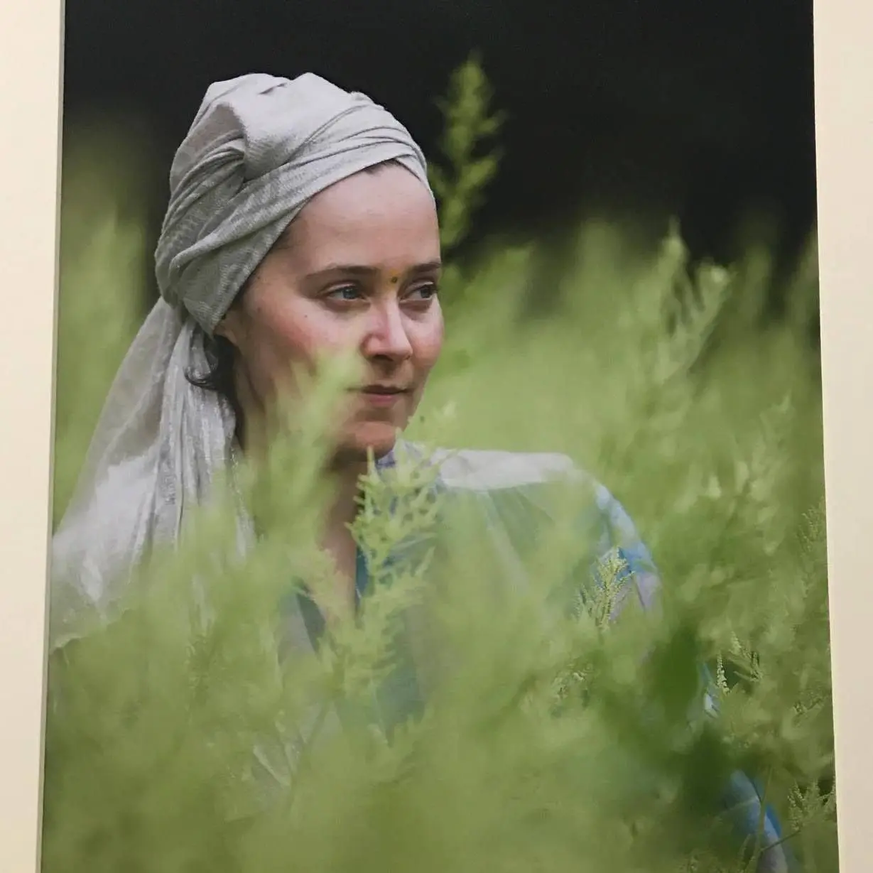 An adult yoga instructor she is wearing a turban
