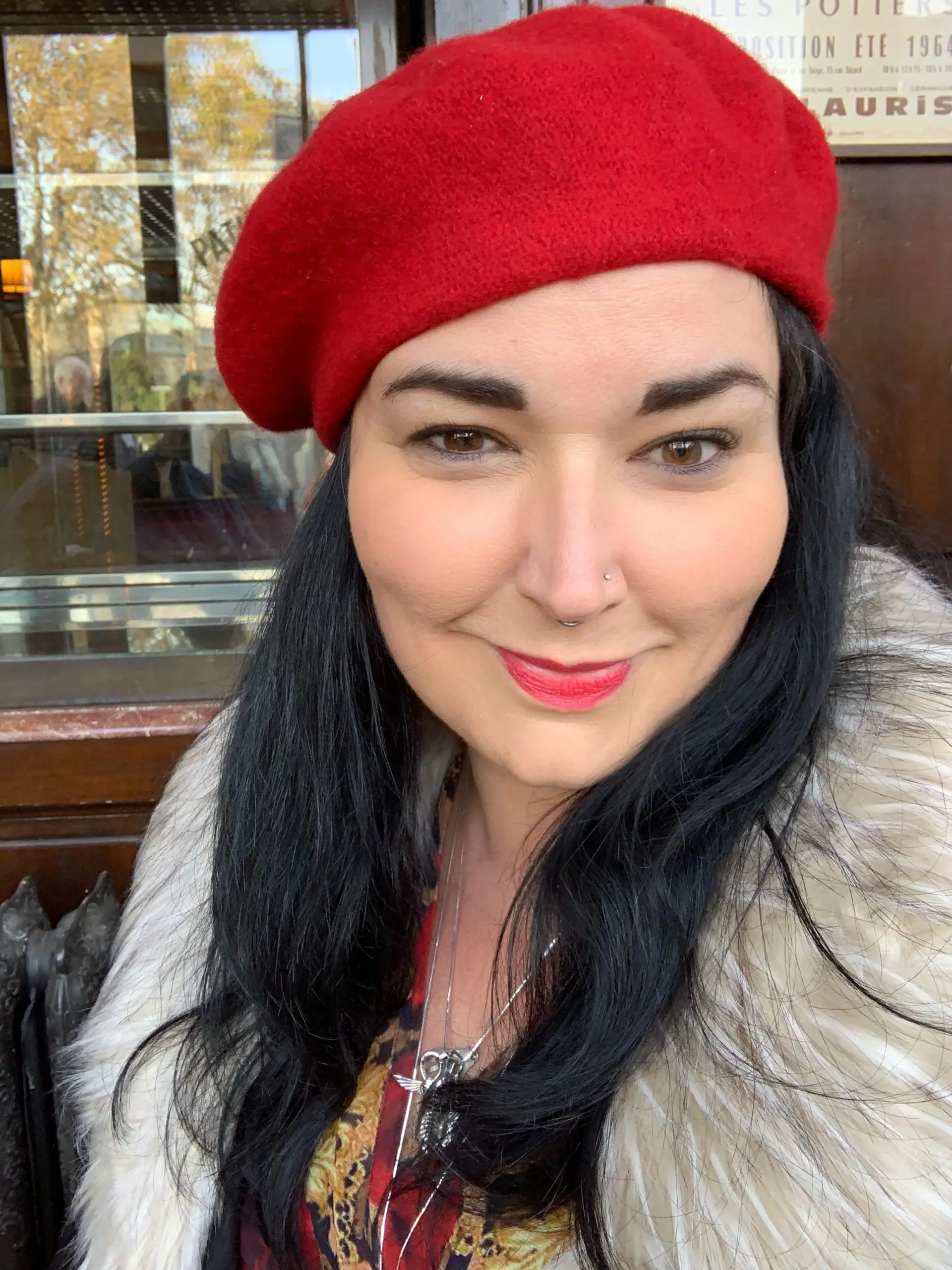A Woman wearing a red cap practicing yoga, with their body, bent backward