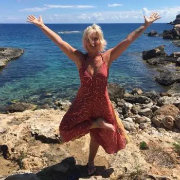 A Woman practicing Rāja yoga, with their body, standing on one leg