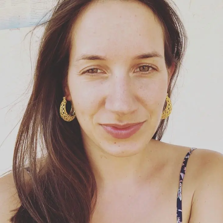 A long-haired young lady, she is looking awesome. | Family Acroyoga class