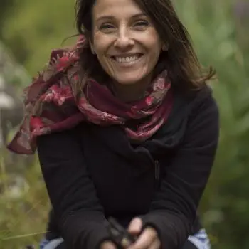 She is very happy after doing yoga exercises and wearing piece handwoven scarf with a black jacket