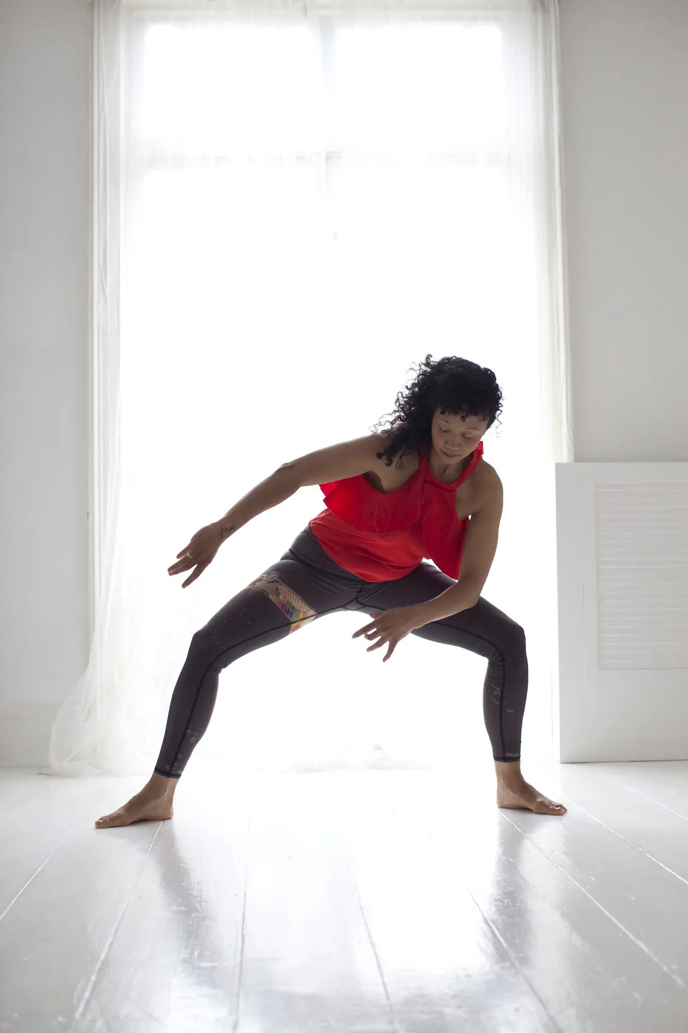 She is standing in Praan Yoga pose in front of the massage room door