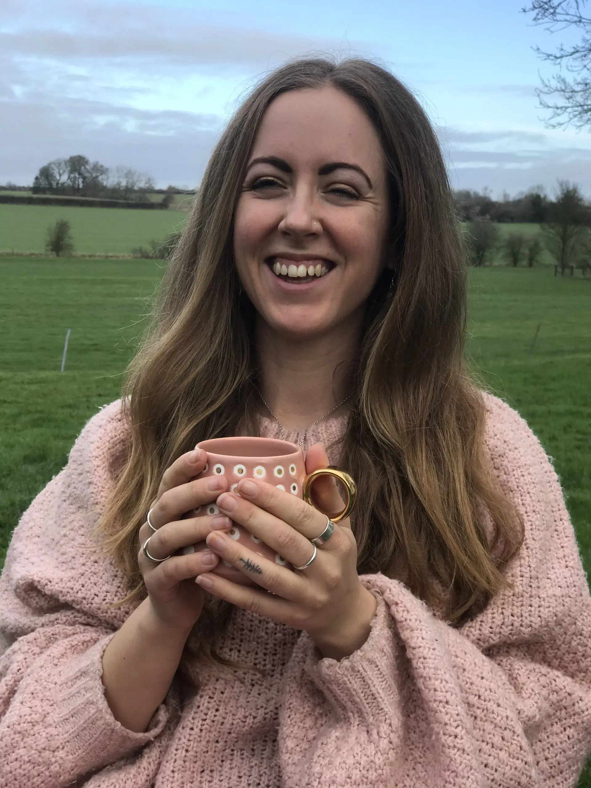 An adult girl enjoying tee time, with a beautiful green view