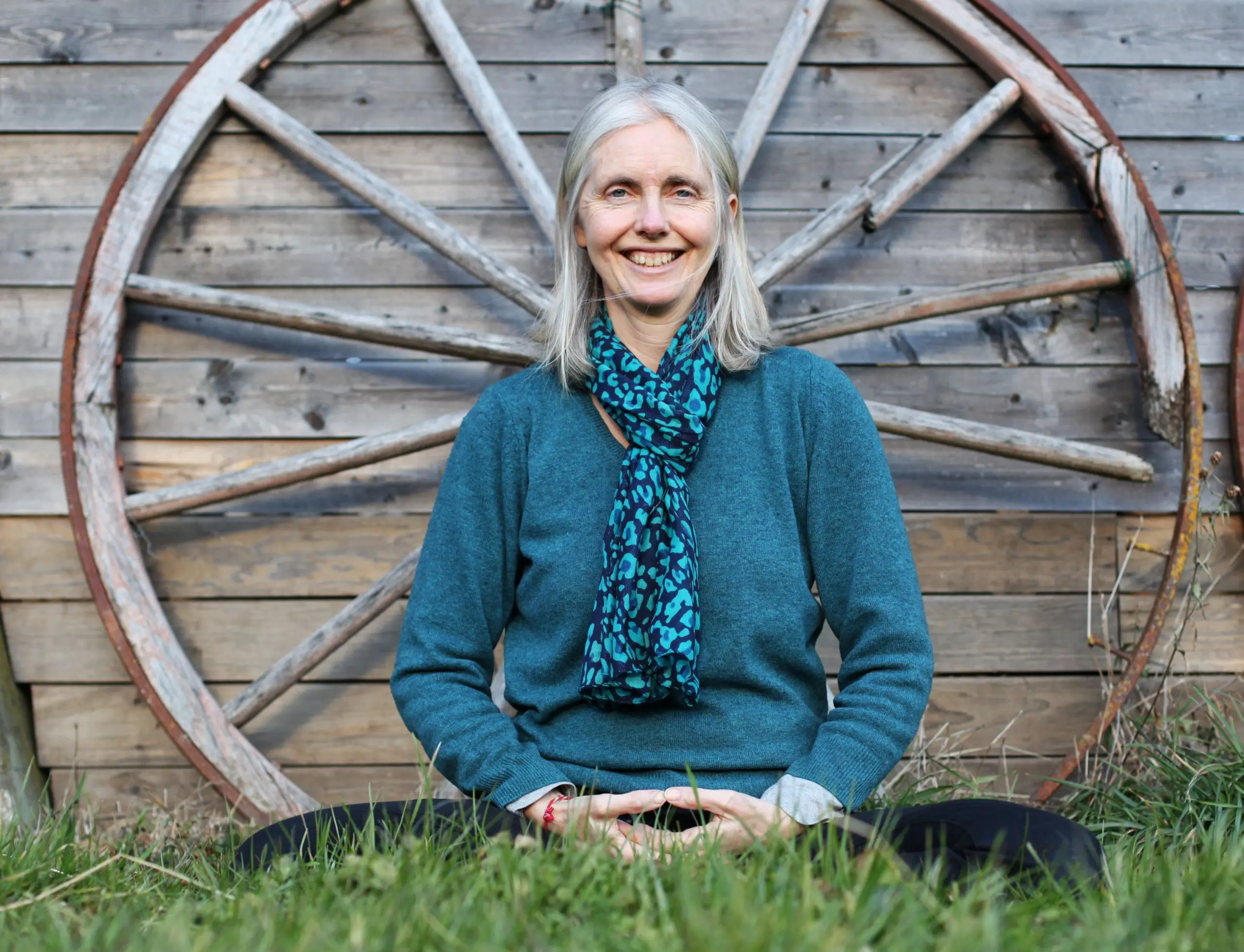 A Woman practicing yoga, with their feet on a wheel-shaped prop