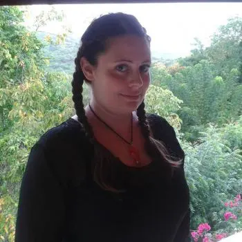 An Indian female yoga instructor, her background capturing the beauty of nature