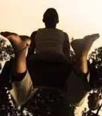 A man is flying at the top of the tree