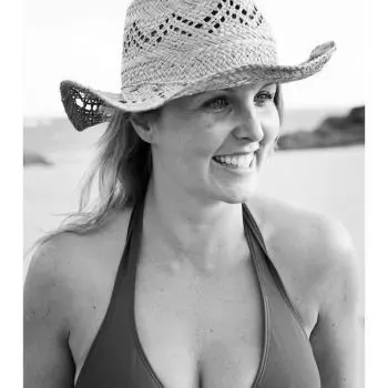 She is wearing a bra and a cap and feeling happy after the shiatsu massage