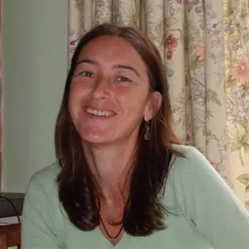 A pretty woman who her long black haired sitting in her massage room