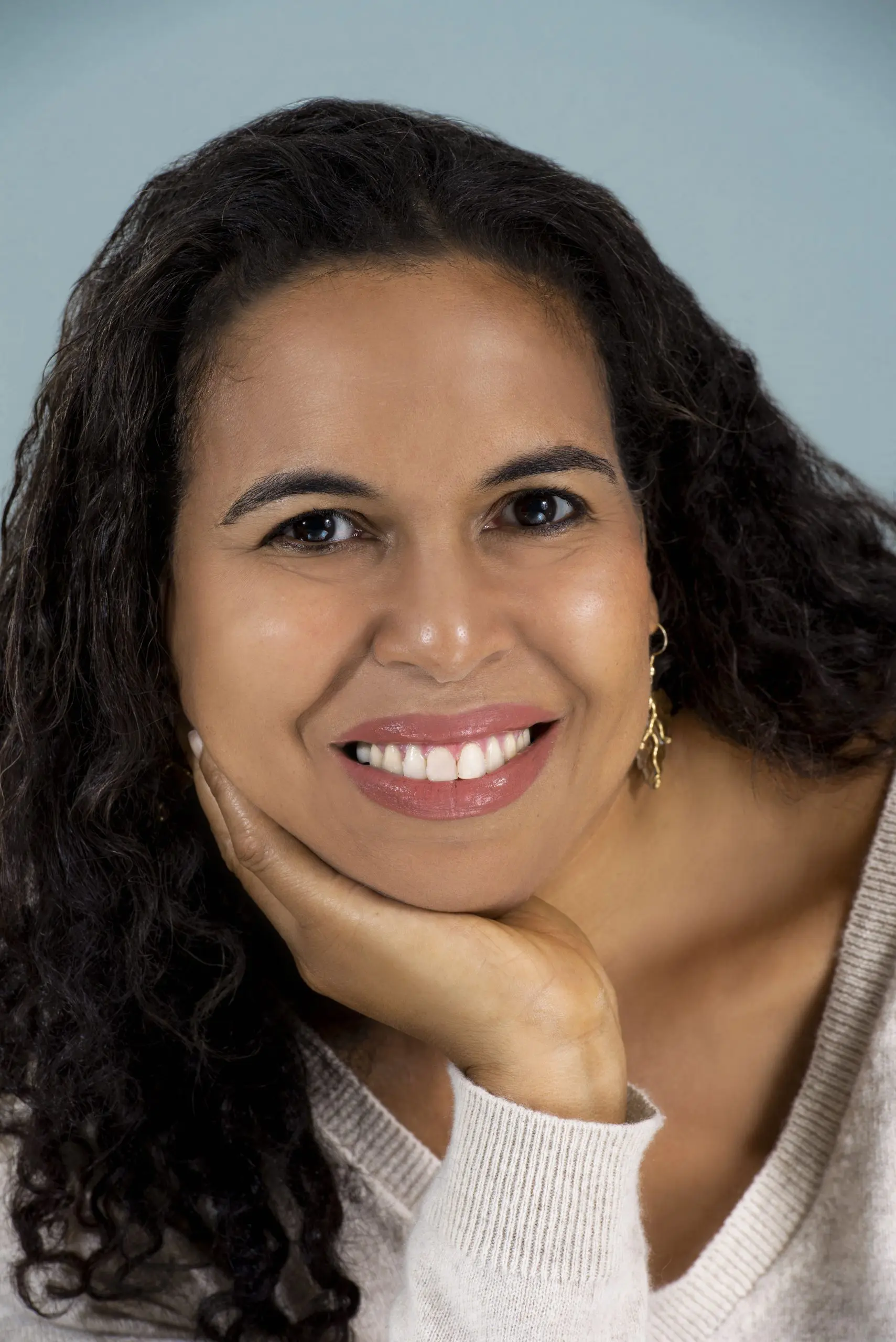 A woman with a wheatish appearance, long hair, and wears a white jersey | Mood-Boosting Therapy Activities