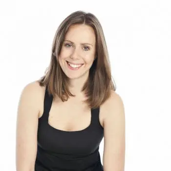 A young lady practicing yoga to pass smiles our audience