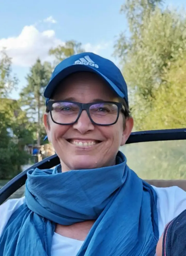 A man is wearing cap-wear glasses and piece handwoven scarf with a natural background | yoga exercises