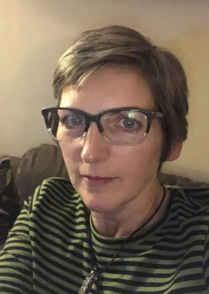 A glasses woman sitting on sofa | Yin Yoga journey