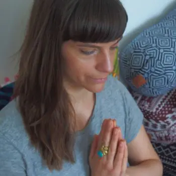 She is sitting on his bed with Molly Maccann's yoga pose and Namaste Symbol