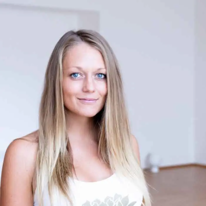 35-year-old woman Looking with regretful eyes at yoga-doing folks