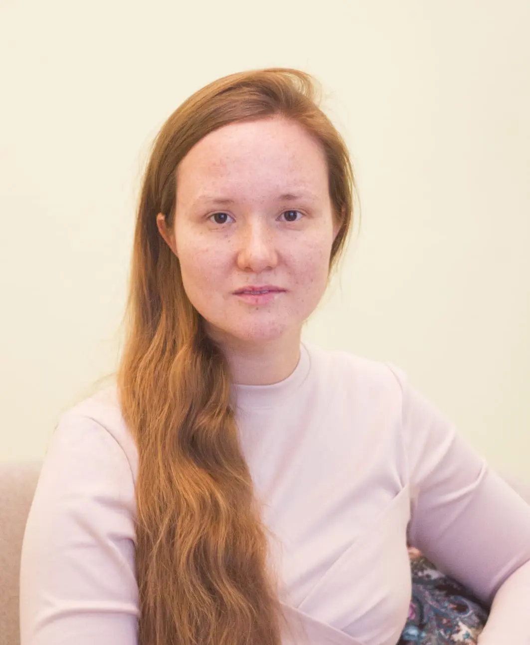 An American long-haired yoga instructor sitting in a massage room