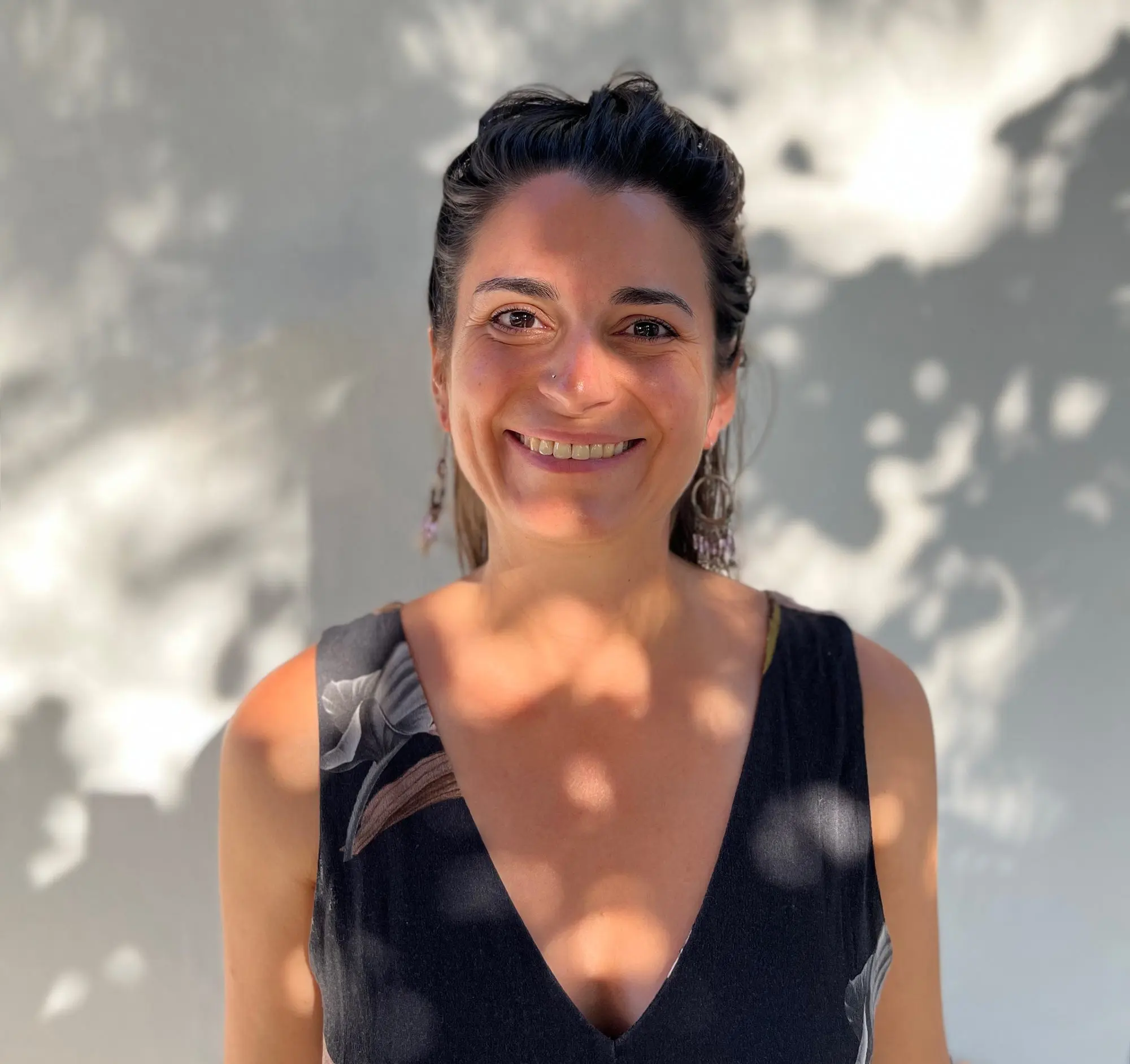 A lovely young Yoga Nidra class teacher standing down in the shade of a tree