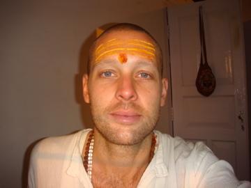 A young Male Yoga instructor is looking like a Hindu Pandit