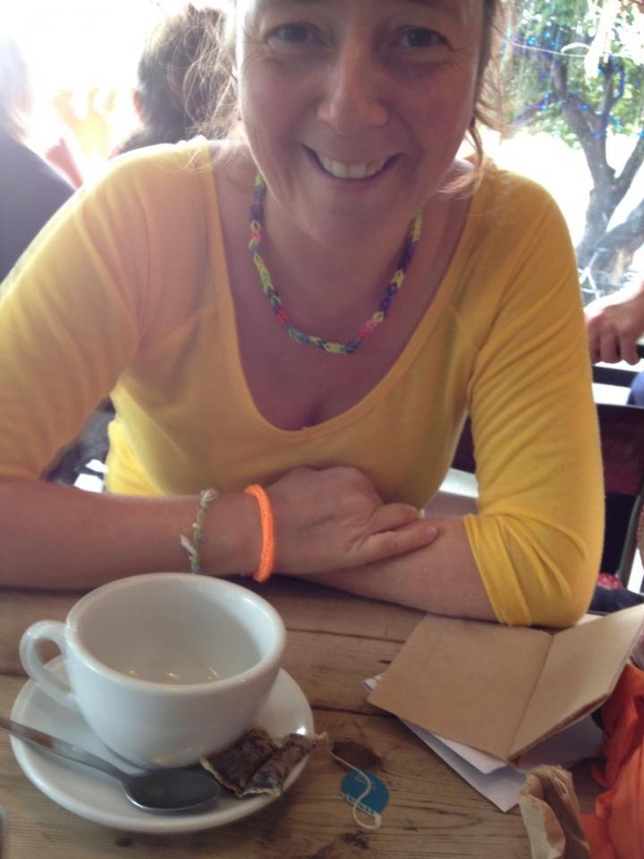 A female Yoga instructor keeping on her front bowl along with following students