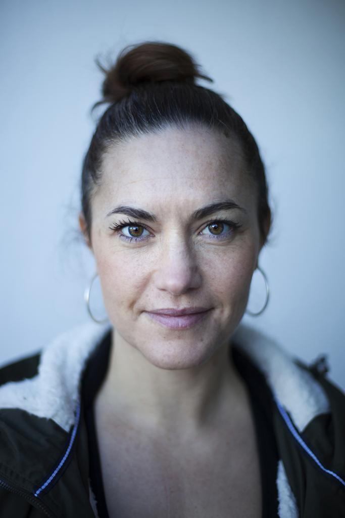 An adult yoga instructor who wearing a black jacket & Jhumke