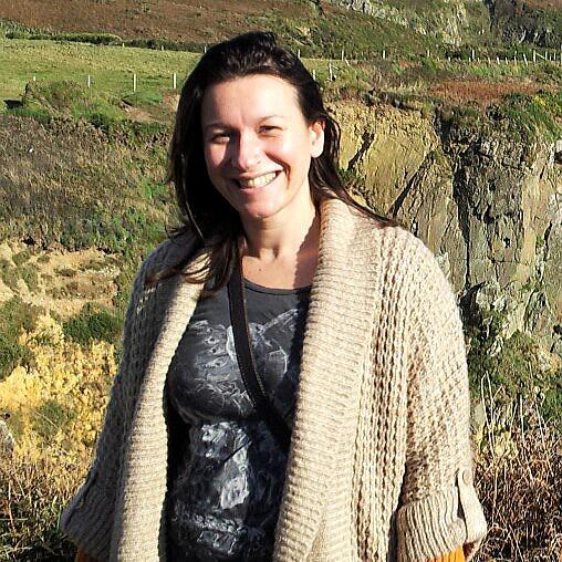 She is very happy with their beautiful surrounded-by-mountain background