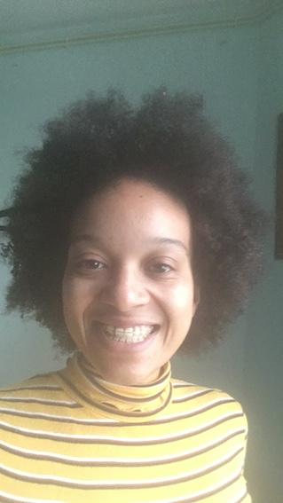 Laughing girl with an ugly smile and her curly hair standing upward
