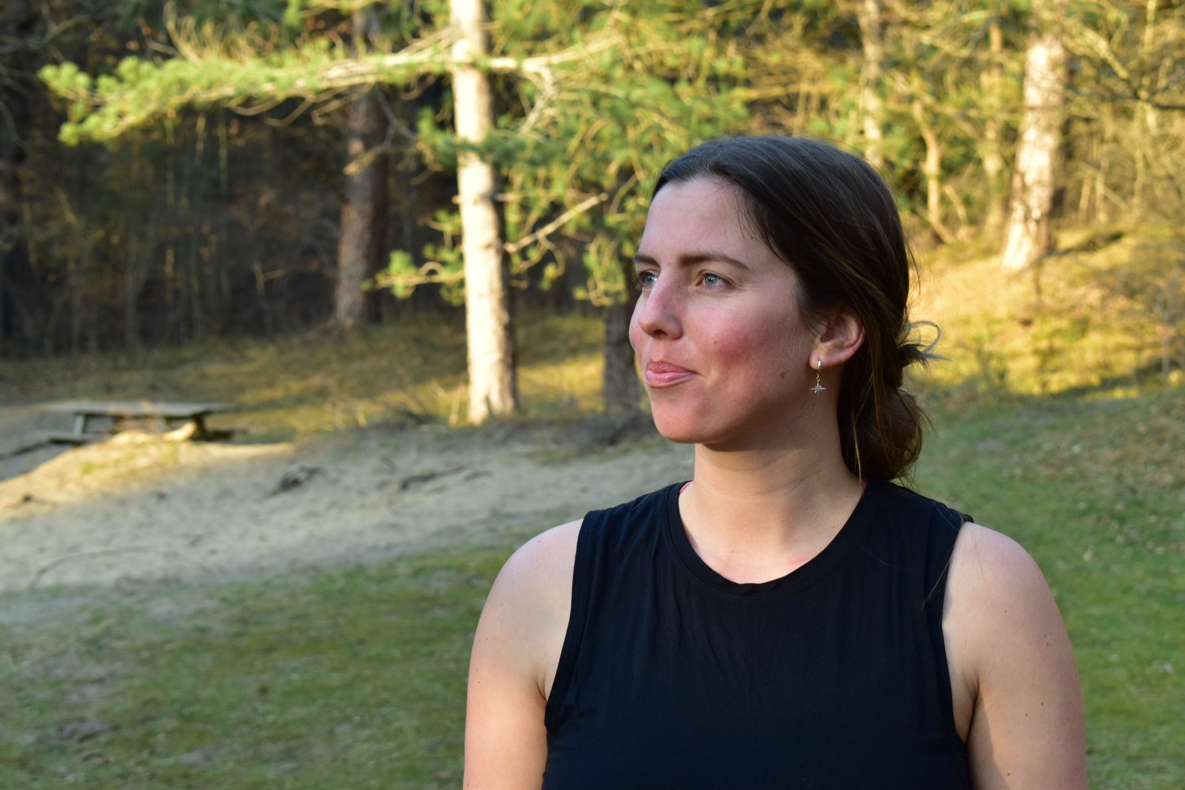 A Women Passing smile with practicing yoga, with their body twisted and their arms extended