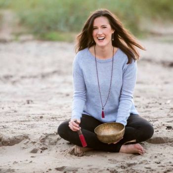 A smily female held Yoga Nindra Katori