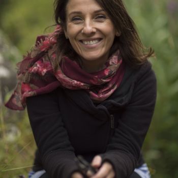 She is very happy after doing yoga exercises and wearing piece handwoven scarf with a black jacket