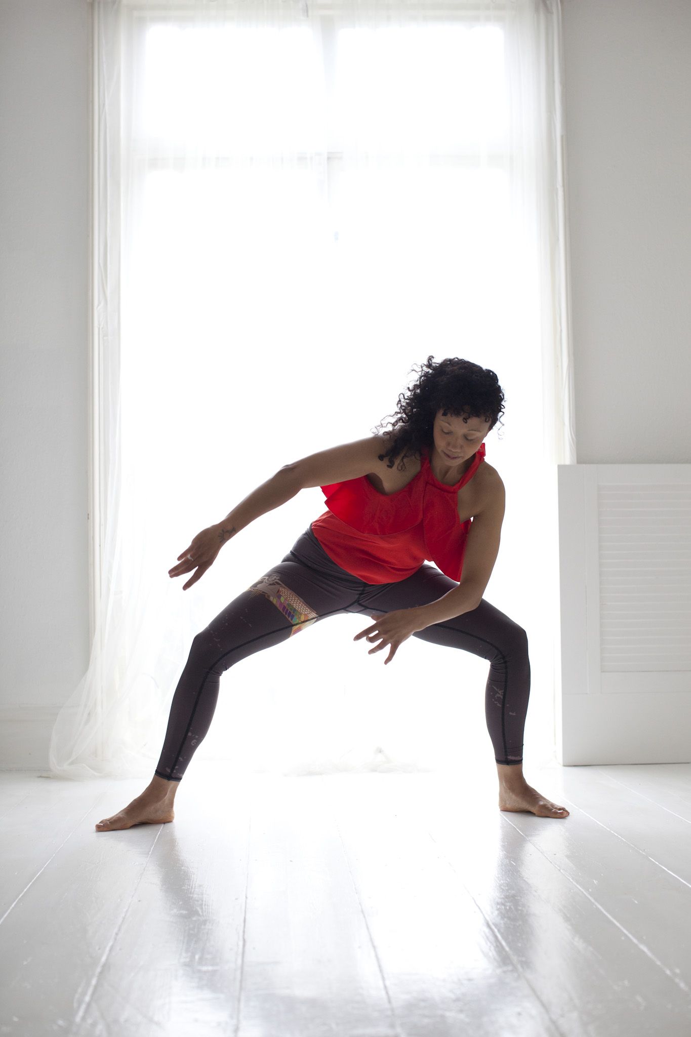 She is standing in Praan Yoga pose in front of the massage room door