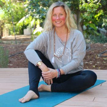 She is sitting with the style of "YIN YANG" Yoga with Gayatri